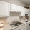 Spacious and well lit kitchen with wood floors and stainless steel appliances 